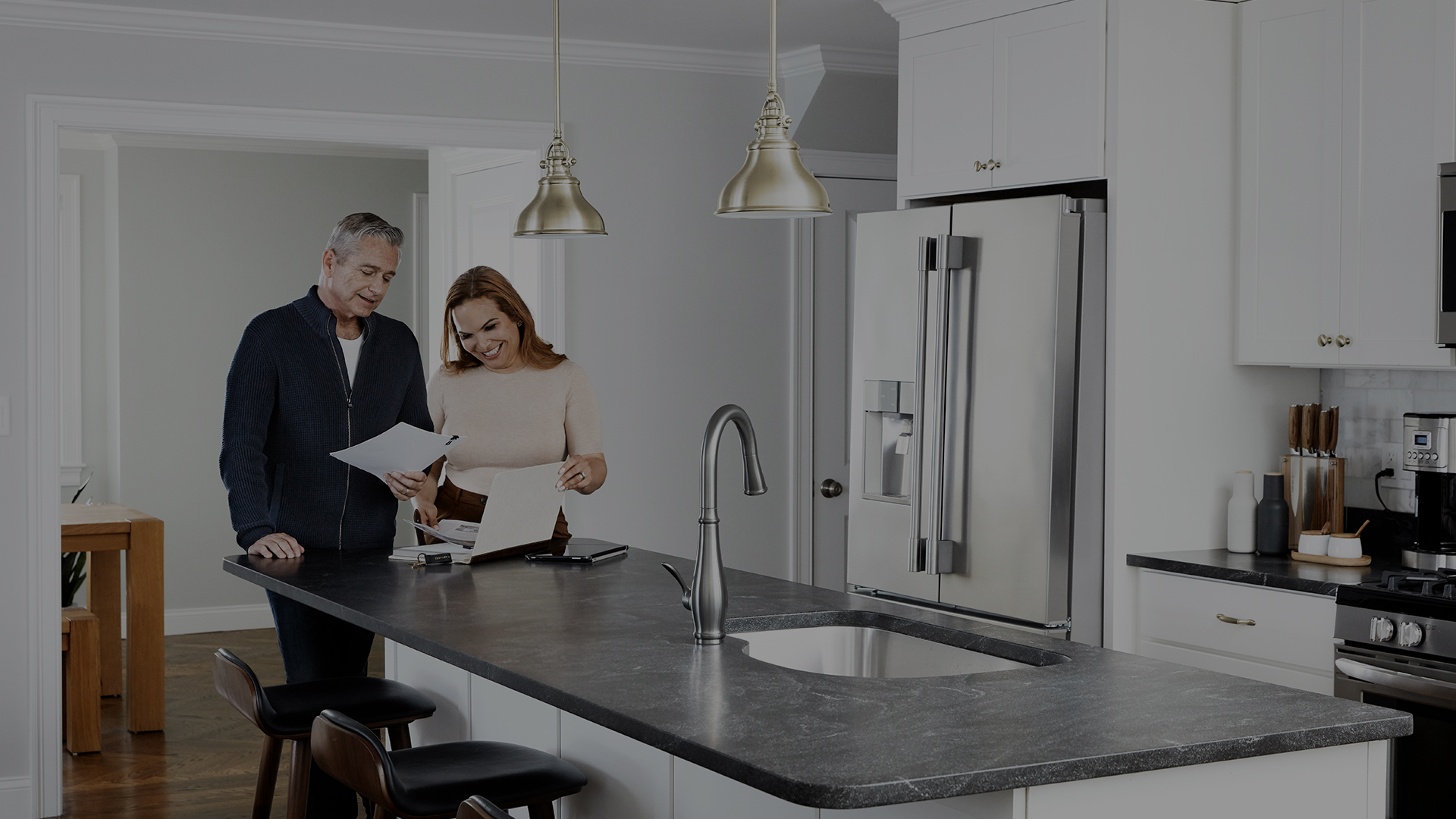 Happy couple reviewing home buying guide